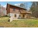 Exterior view of home with brick foundation, wood siding, and a back deck at 1266 Martin Mill Rd, Moreland, GA 30259