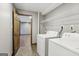 Functional laundry area featuring washer, dryer, and wire shelving at 1266 Martin Mill Rd, Moreland, GA 30259