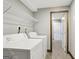 Well-lit laundry area with shelving and a side-by-side washer and dryer at 1266 Martin Mill Rd, Moreland, GA 30259