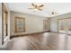 Bright, open living room with wood-look flooring, ceiling fans and natural light from the outdoors at 1266 Martin Mill Rd, Moreland, GA 30259