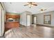 Open living room and kitchen area with wood-look flooring, stainless steel appliances and breakfast bar at 1266 Martin Mill Rd, Moreland, GA 30259