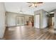 Open-concept living room features wood-look floors, neutral walls, and access to the kitchen and outdoor deck at 1266 Martin Mill Rd, Moreland, GA 30259