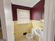 Bathroom with yellow tile walls, featuring a sink and toilet at 1683 Candler Rd, Decatur, GA 30032