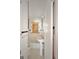 Modest bathroom featuring white tile and pedestal sink; boarded window shown at 1683 Candler Rd, Decatur, GA 30032