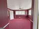 A bedroom with red carpets and maroon walls is connected to a hallway at 1683 Candler Rd, Decatur, GA 30032