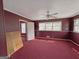 Bedroom with maroon walls and red carpets, features a ceiling fan at 1683 Candler Rd, Decatur, GA 30032