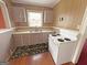 Traditional kitchen with white appliances, classic cabinets, and a laminate countertop at 1683 Candler Rd, Decatur, GA 30032