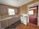 Traditional kitchen with white appliances, classic cabinets, and a laminate countertop at 1683 Candler Rd, Decatur, GA 30032
