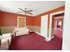 Cozy living room with red walls, ceiling fan, and couch at 1683 Candler Rd, Decatur, GA 30032