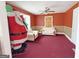 Living room with red walls, ceiling fan, couches, and holiday decorations at 1683 Candler Rd, Decatur, GA 30032