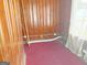 Wood-paneled room with red carpet features exposed utilities and a window at 1683 Candler Rd, Decatur, GA 30032