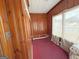 Wood-paneled room with red carpet features exposed utilities and a window at 1683 Candler Rd, Decatur, GA 30032