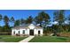 Community clubhouse featuring white siding, black trim, a playground, and well-manicured lawn at 166 Silverton Dr, Dacula, GA 30019