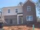 Two story home featuring a 2 car garage, and a combination of brick and vertical siding at 166 Silverton Dr, Dacula, GA 30019