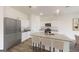 Well-lit kitchen featuring stainless steel appliances, granite countertops, and a central island with bar seating at 166 Silverton Dr, Dacula, GA 30019