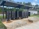 Mailbox kiosk featuring covered mailboxes with brick accents with community pool and clubhouse in the background at 166 Silverton Dr, Dacula, GA 30019
