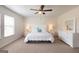 Bright main bedroom featuring plush carpeting, a ceiling fan and a large window at 166 Silverton Dr, Dacula, GA 30019