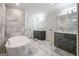 Spacious bathroom with a modern tub, tiled floors and double vanities with black cabinets at 2431 Weatherford Ct, Marietta, GA 30068