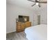 This bedroom features wood-look floors, ceiling fan and large television at 2431 Weatherford Ct, Marietta, GA 30068