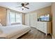 Bright bedroom features neutral tones, ceiling fan, and dresser with television at 2431 Weatherford Ct, Marietta, GA 30068