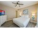 Bright bedroom features neutral tones, ceiling fan, and beach-themed artwork at 2431 Weatherford Ct, Marietta, GA 30068