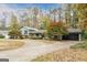Single-Gathering home with mature trees and a long concrete driveway at 2431 Weatherford Ct, Marietta, GA 30068