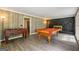 Entertaining game room with pool table, foosball and a charming stone fireplace at 2431 Weatherford Ct, Marietta, GA 30068