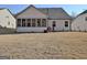 This expansive backyard includes a screened-in porch and space for outdoor dining at 82 Airmont Dr, Sharpsburg, GA 30277