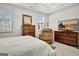 Bright bedroom featuring a flat-screen TV, large windows, a reading chair, and plush carpeting at 82 Airmont Dr, Sharpsburg, GA 30277