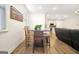 This open concept living area has dining space with a wooden table set and kitchen views at 82 Airmont Dr, Sharpsburg, GA 30277
