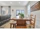 Bright dining area with a wooden table set, view to living room and screened porch at 82 Airmont Dr, Sharpsburg, GA 30277
