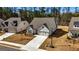 Lovely traditional home with a large driveway and attached garage, with a well-manicured lawn and landscaping at 82 Airmont Dr, Sharpsburg, GA 30277