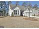 Charming traditional home with stone accents, a well-maintained lawn, and an attached garage, nestled in a friendly community at 82 Airmont Dr, Sharpsburg, GA 30277