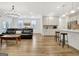 Spacious open-concept living area showcasing wood floors and modern kitchen at 82 Airmont Dr, Sharpsburg, GA 30277