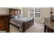 Cozy bedroom featuring neutral walls, carpet, a large window, and a bed with decorative pillows at 2361 Hanover Woods Rd, Lithonia, GA 30058
