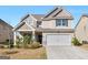 Charming two-story home boasts neutral siding, a two-car garage, and a well-maintained front lawn at 2361 Hanover Woods Rd, Lithonia, GA 30058