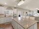 Eat in kitchen features a large island with modern white cabinetry at 2361 Hanover Woods Rd, Lithonia, GA 30058