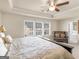 Bright main bedroom featuring a tray ceiling, carpet, sitting area, and large windows at 2361 Hanover Woods Rd, Lithonia, GA 30058