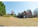 Large backyard with a grassy lawn and mature trees, perfect for outdoor activities at 408 Tomahawk Trl, Mcdonough, GA 30252
