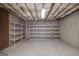 The unfinished basement offers great potential for storage with installed shelving and a concrete floor at 408 Tomahawk Trl, Mcdonough, GA 30252