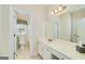 Clean bathroom featuring white cabinets, a large mirror, and an adjoining water closet at 408 Tomahawk Trl, Mcdonough, GA 30252