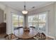 Bright dining room with large windows and a wood table at 408 Tomahawk Trl, Mcdonough, GA 30252