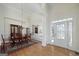 Spacious dining room with natural light, beautiful hardwood floors, and a large dining table at 408 Tomahawk Trl, Mcdonough, GA 30252