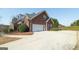 Long driveway leading to a two-car garage with ample parking space at 408 Tomahawk Trl, Mcdonough, GA 30252