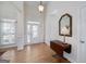 Elegant foyer features hardwood floors, a stylish light fixture, and an inviting entrance with sidelights at 408 Tomahawk Trl, Mcdonough, GA 30252