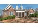 Charming brick home featuring a covered front porch and well-maintained landscaping at 408 Tomahawk Trl, Mcdonough, GA 30252