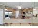 Kitchen features granite countertops, stainless steel refrigerator, and hardwood cabinetry at 408 Tomahawk Trl, Mcdonough, GA 30252