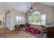 Sun-filled living room features large windows and hardwood floors at 408 Tomahawk Trl, Mcdonough, GA 30252