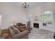 Bright living room features a fireplace, arch windows, and comfortable seating at 408 Tomahawk Trl, Mcdonough, GA 30252