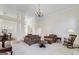 Open-concept living room with fireplace and comfortable seating next to the dining room with hardwood floors at 408 Tomahawk Trl, Mcdonough, GA 30252